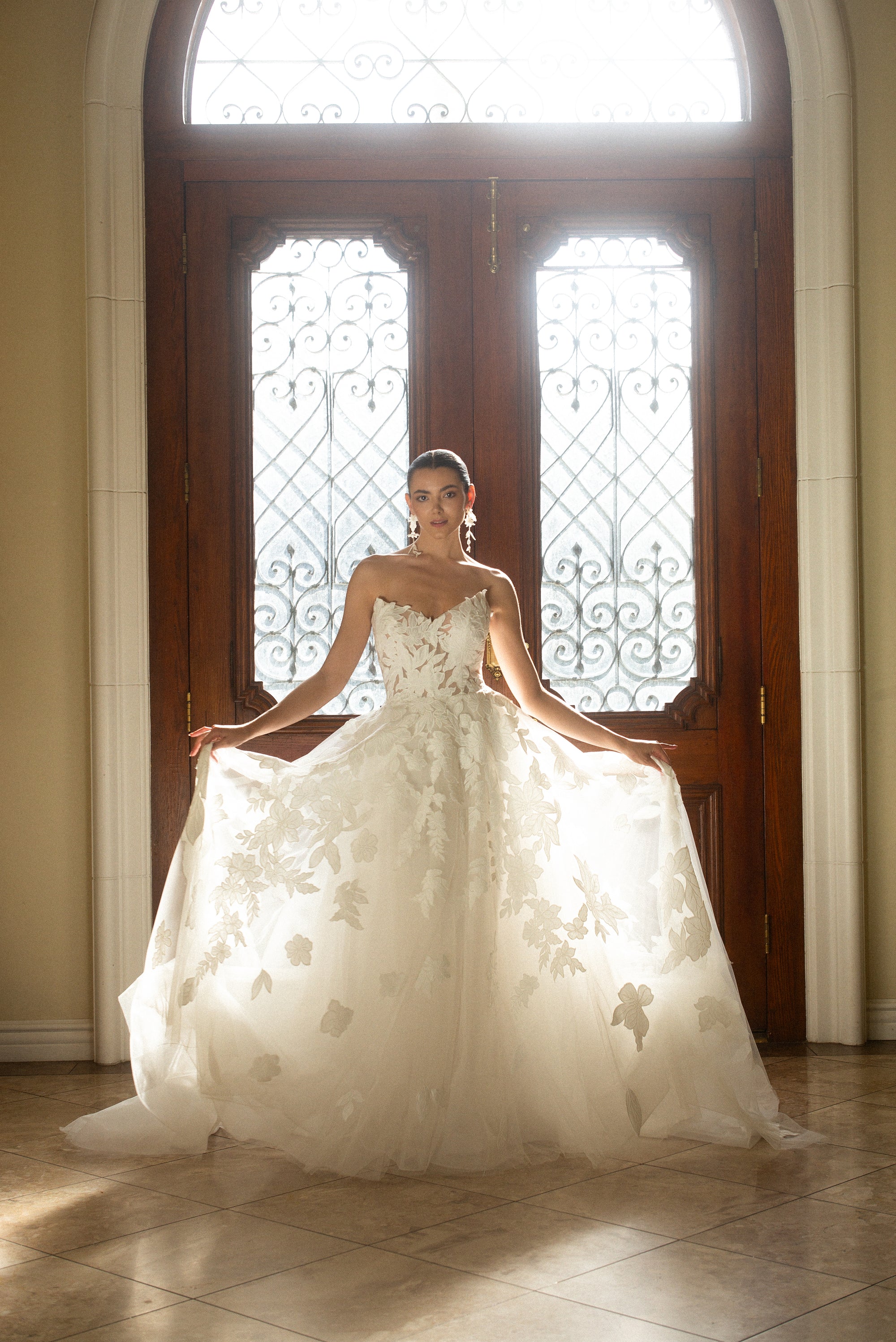 Front view of the Sovereign floral organza ball gown with a plunging V neckline and dimensional floral appliqué