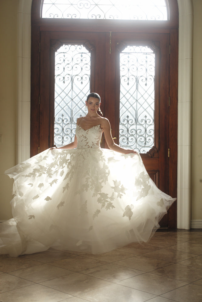 The Sovereign floral organza wedding dress shown in motion with a full appliquéd skirt
