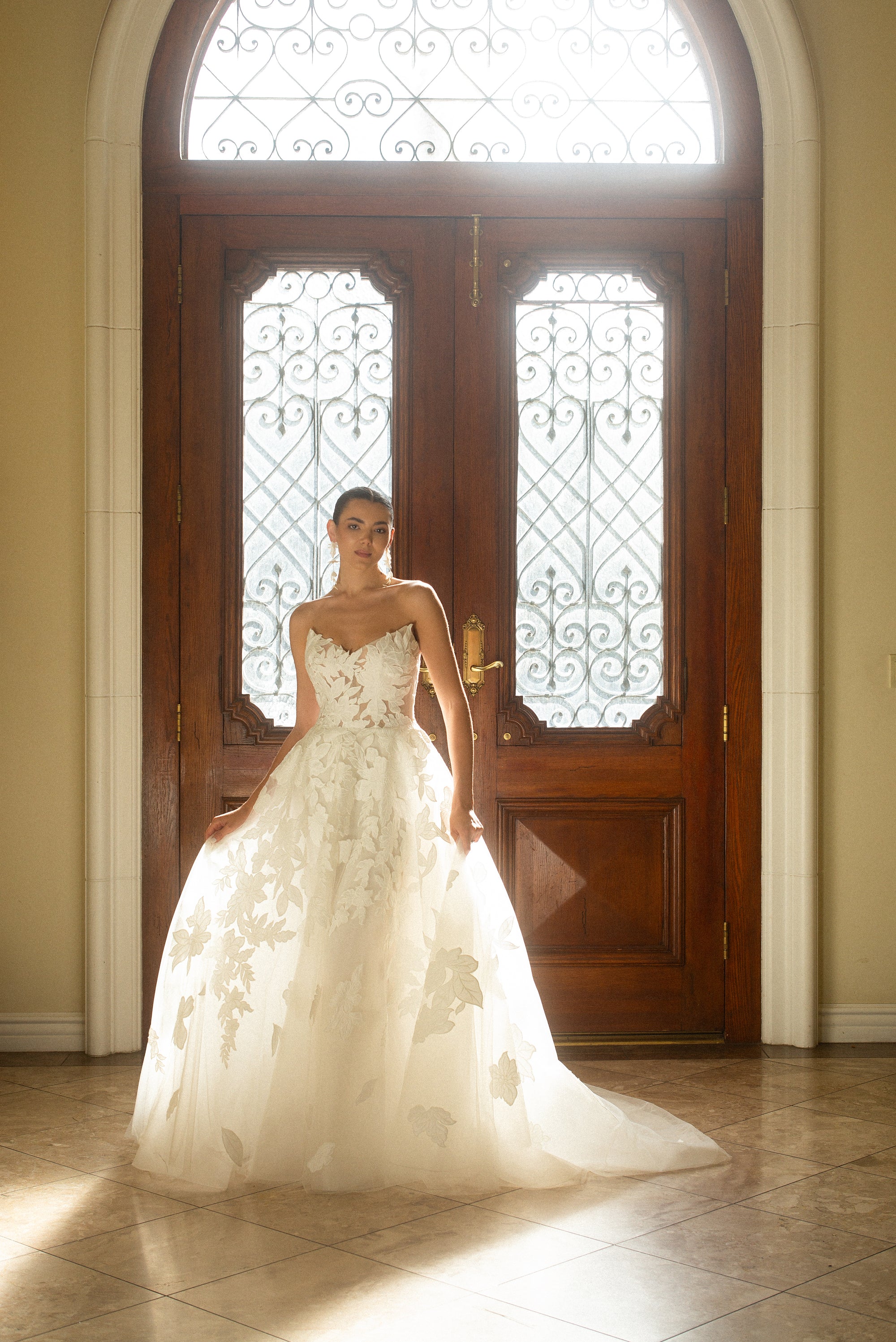 Full front view of the Sovereign organza ball gown with a structured strapless bodice and sweeping train