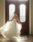 Side view of the Sovereign organza ball gown in motion with dimensional floral appliqué and airy volume