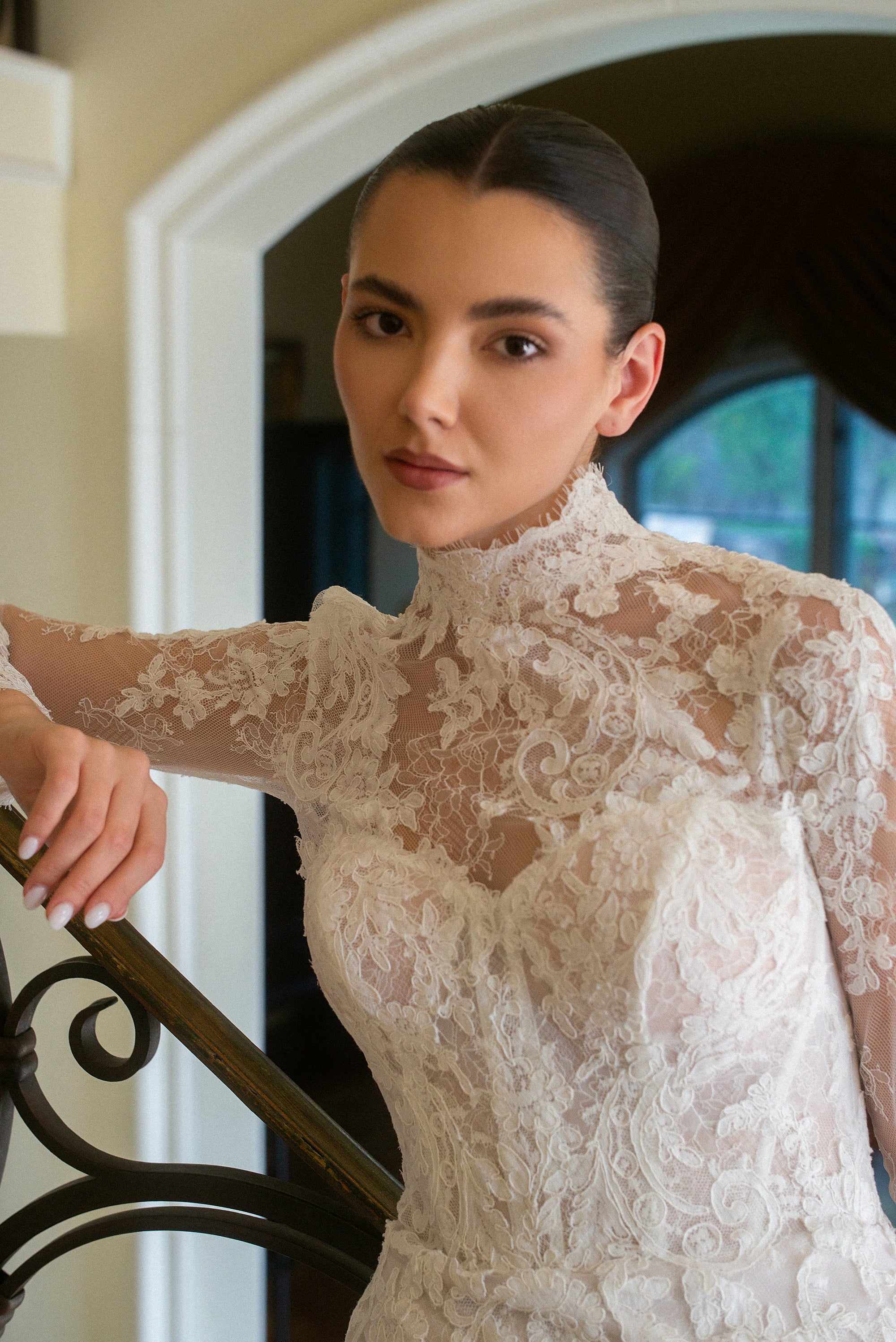 Close-up of the Valentina detachable high-neck French lace jacket with sheer long sleeves and floral lace appliqué