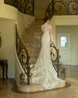 Back view of the Valentina wedding dress with a detachable high-neck lace jacket and sweeping lace train