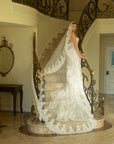 Side view of the Valentina French lace wedding dress styled with a cathedral-length lace veil